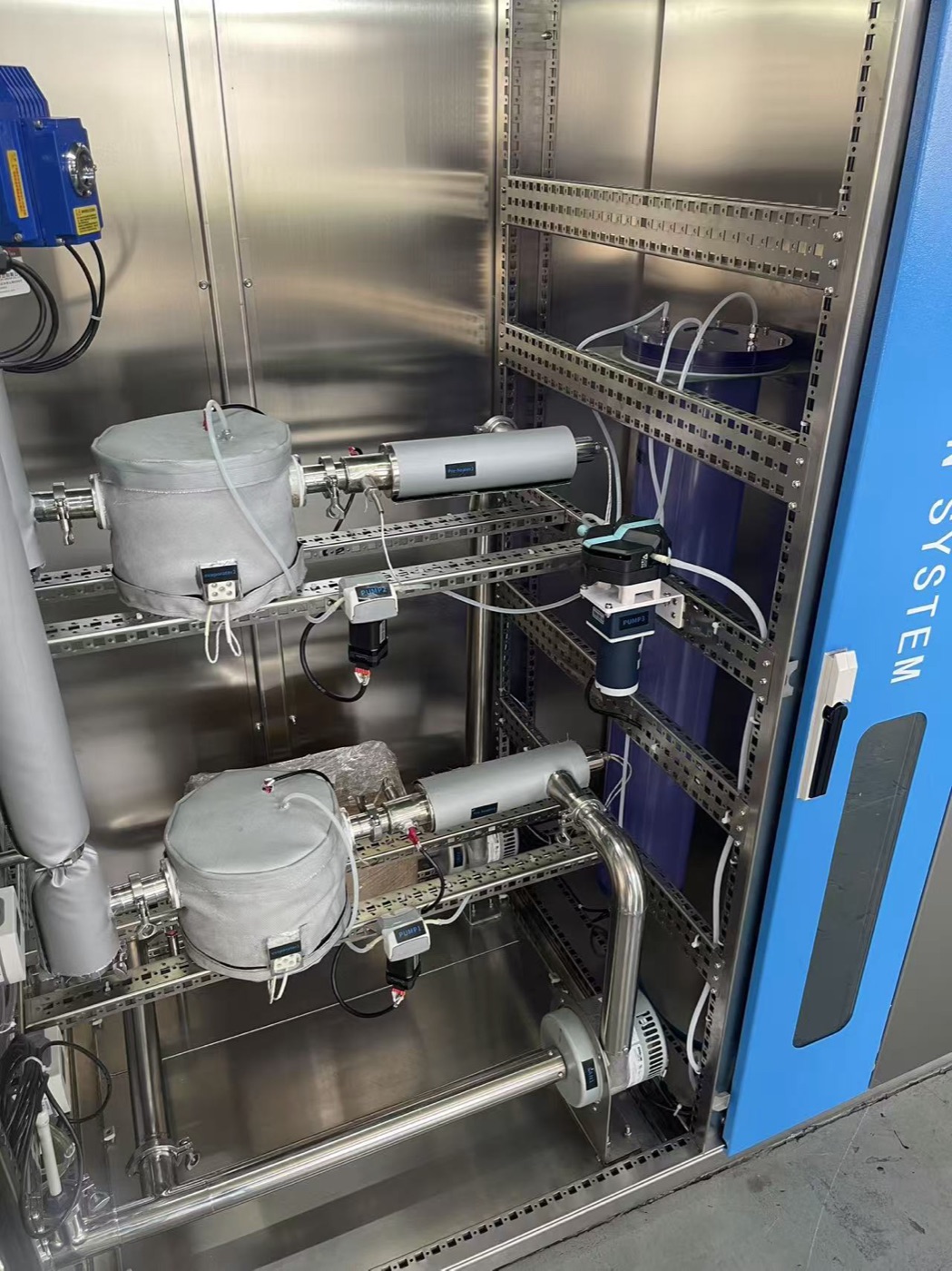 Inside the VHP sterilization cabinet: two evaporator and blower assemblies